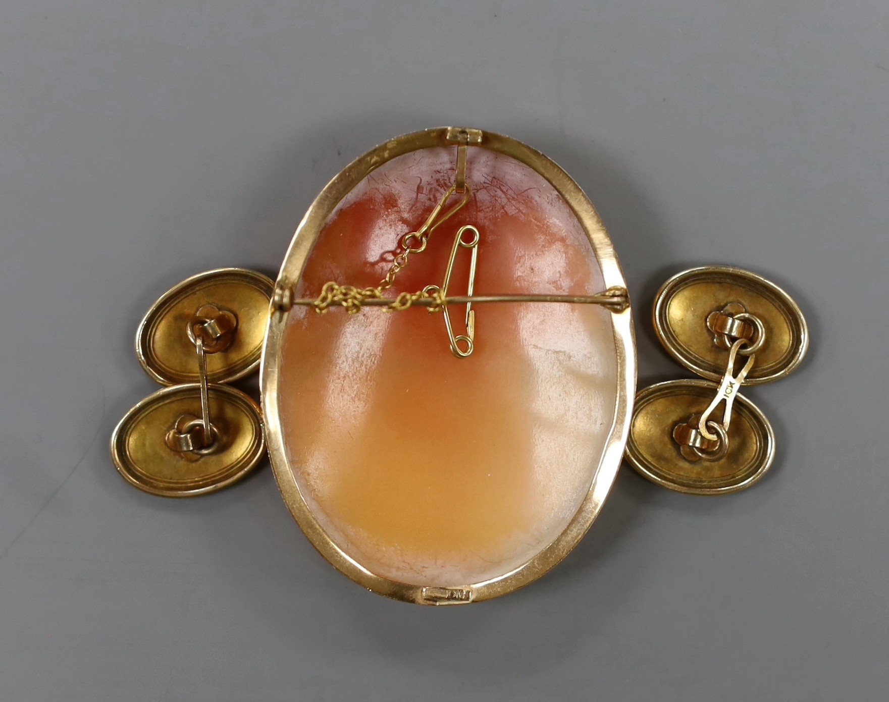 A pair of yellow metal oval cufflinks, 4.1 grams and an Italian 9k mounted oval cameo shell brooch.